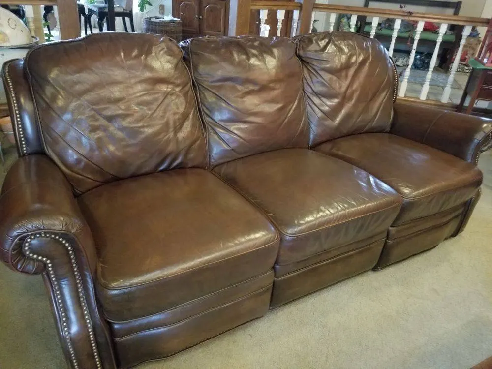 Brown sofa cushion with peeling finish before restoration