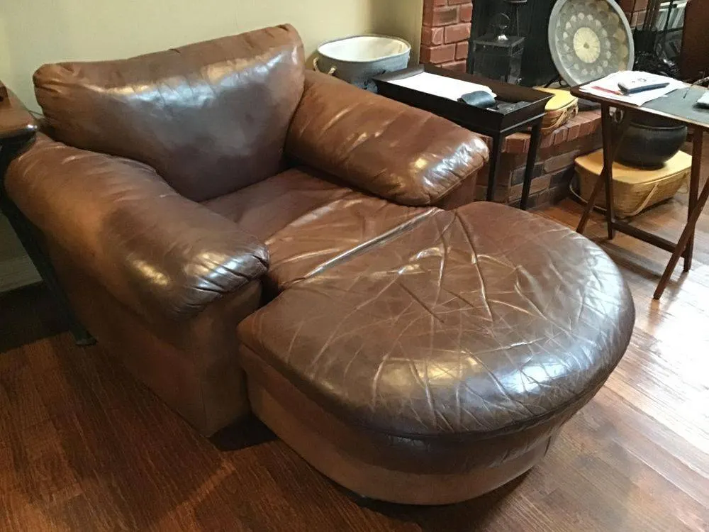 Scratched leather chair and ottoman before scratch repair