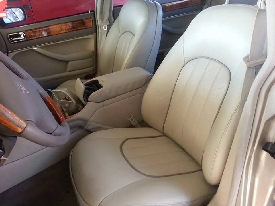 Cream vehicle seats showing light discoloration across the seating surfaces