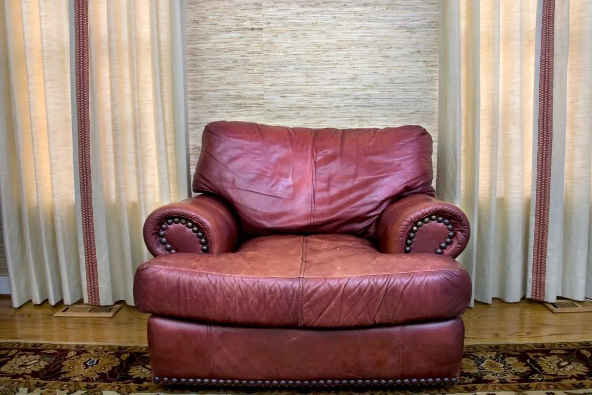 Maroon upholstered armchair after seat and arm repair